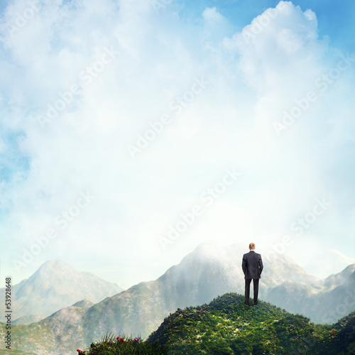 Photo: businessman standing on a peak businessman standing on a peak