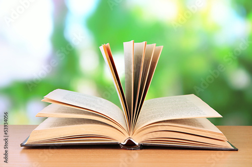 Photo: Opened book on bright background Opened book on bright background