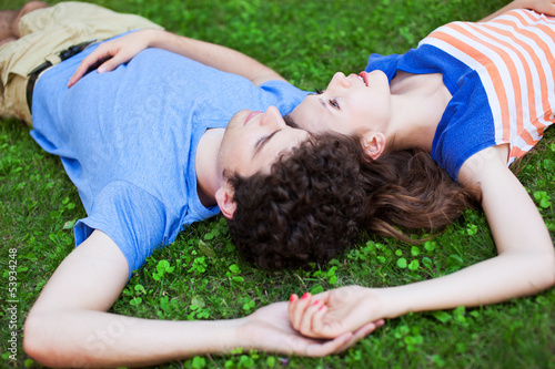 Photo: Young couple lying on grass Young couple lying on grass