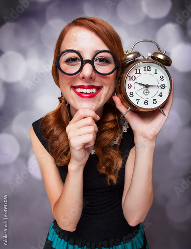 Photo: Surprised redhead girl with clock. Surprised redhead girl with clock.