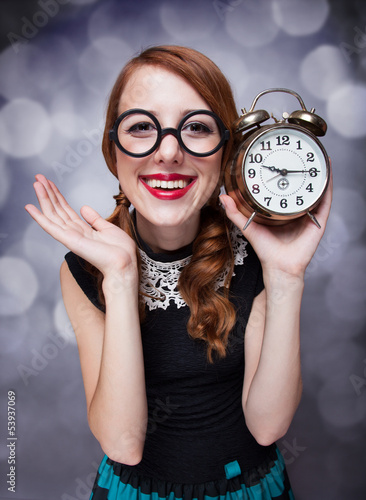 Photo: Surprised redhead girl with clock. Surprised redhead girl with clock.