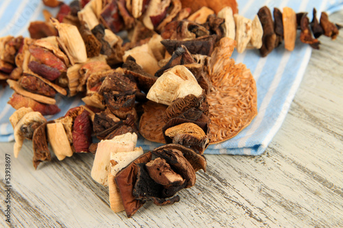 Photo: Dried mushrooms on wooden background Dried mushrooms on wooden background