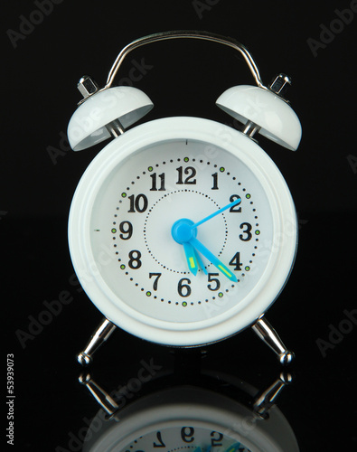Photo: Old style alarm clock isolated on black Old style alarm clock isolated on black