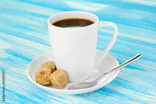 Photo: Cup of coffee, on color wooden background Cup of coffee, on color wooden background
