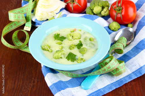 Photo: Cabbage soup in plates on napkin on wooden table Cabbage soup in plates on napkin on wooden table