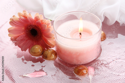 Photo: Beautiful pink candle with flower in water Beautiful pink candle with flower in water