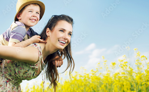 Photo: Charming mother carrying her cute son Charming mother carrying her cute son