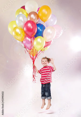 Photo: Cute small kid hovering by the ballons Cute small kid hovering by the ballons