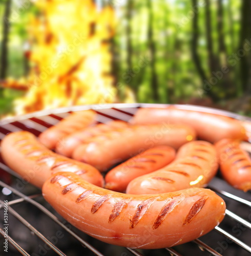 Photo: Sausages on a grill. Sausages on a grill.