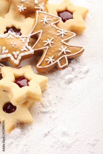 Photo: White wooden board and Christmas cookies and powdered sugar. White wooden board and Christmas cookies and powdered sugar.