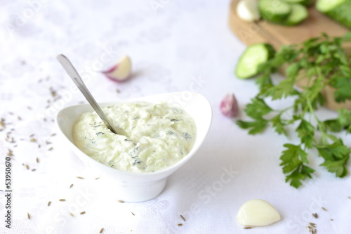 Photo: Sauce of yogurt, cucumber, dill, selective focus Sauce of yogurt, cucumber, dill, selective focus