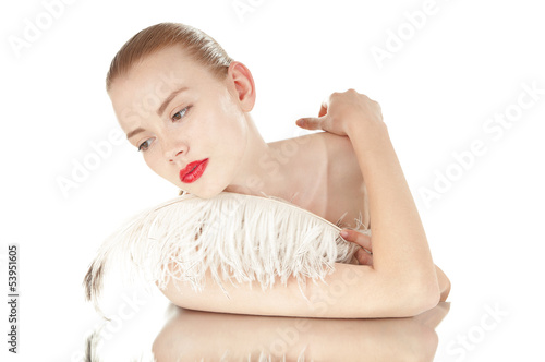 Photo: Portrait of a beautiful woman with white feather over white Portrait of a beautiful woman with white feather over white