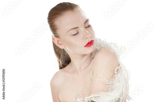 Photo: Portrait of a beautiful woman with white feather over white Portrait of a beautiful woman with white feather over white