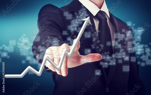 Photo: Businessman Touching a Rising Arrow Businessman Touching a Rising Arrow