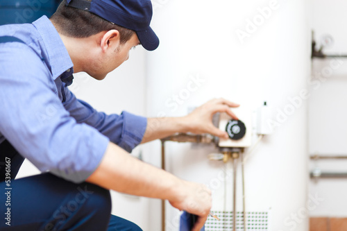 Photo: Plumber repairing an hot-water heater Plumber repairing an hot-water heater