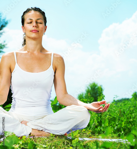 Photo: Yoga. Young woman doing yoga exercise outdoor Yoga. Young woman doing yoga exercise outdoor