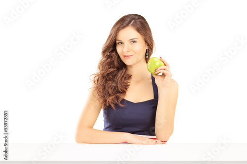 Photo: Beautiful female holding a green apple Beautiful female holding a green apple
