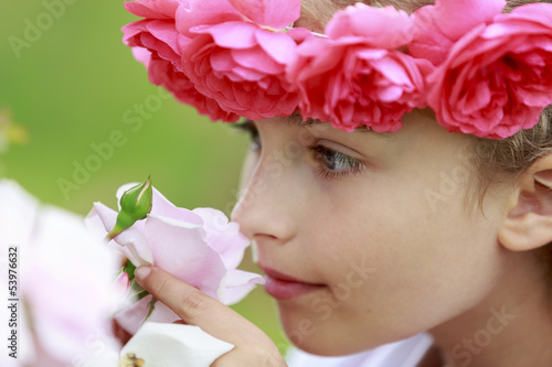 Photo: Rose garden - beautiful girl playing in the rose garden Rose garden - beautiful girl playing in the rose garden