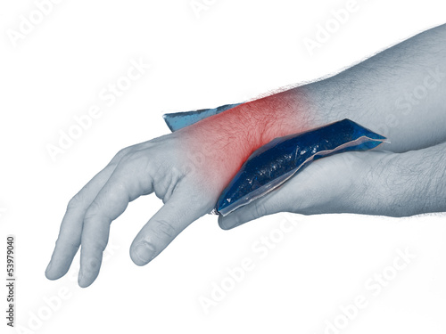 Photo: Wrist pain. Male holding ice pack on wrist. Wrist pain. Male holding ice pack on wrist.