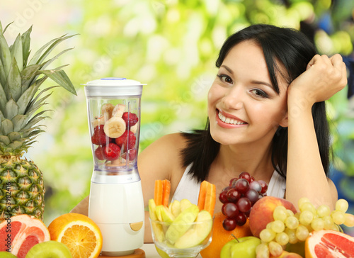 Photo: Girl with fresh fruits on natural background Girl with fresh fruits on natural background