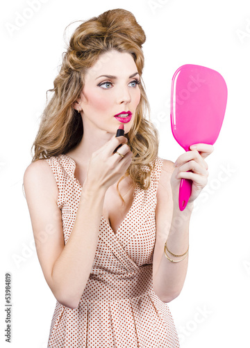 Photo: Woman applying lip makeup with cosmetics mirror Woman applying lip makeup with cosmetics mirror