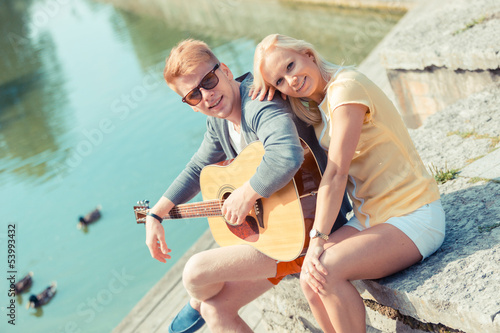 Photo: Young Couple with Guitar at Park Young Couple with Guitar at Park