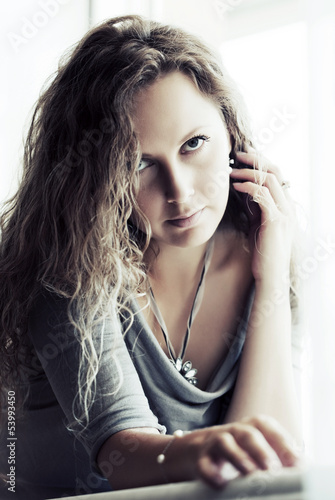 Photo: Sad beautiful woman against a window Sad beautiful woman against a window