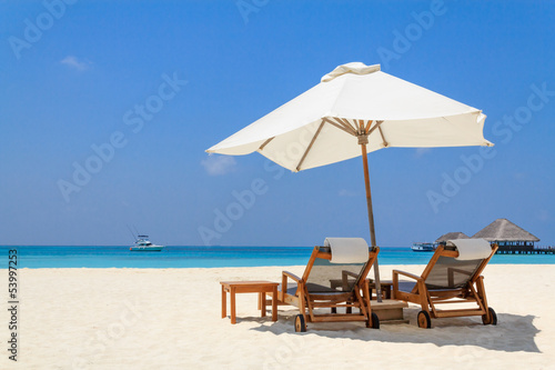 Photo: Scenery of the beach with a white parasol Scenery of the beach with a white parasol