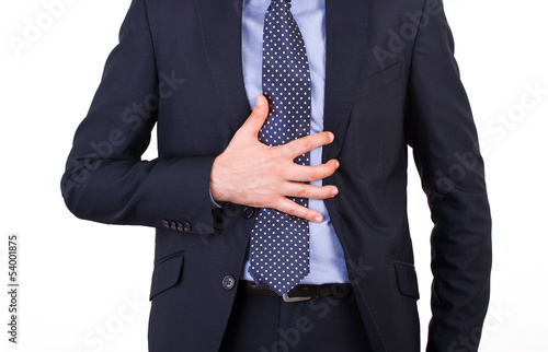 Photo: Businessman suffering from heartburn. Businessman suffering from heartburn.