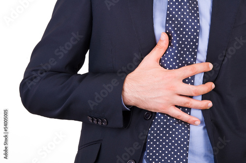 Photo: Businessman suffering from heartburn. Businessman suffering from heartburn.