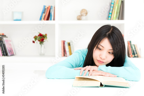 Photo: attractive asian woman reading book in the room attractive asian woman reading book in the room