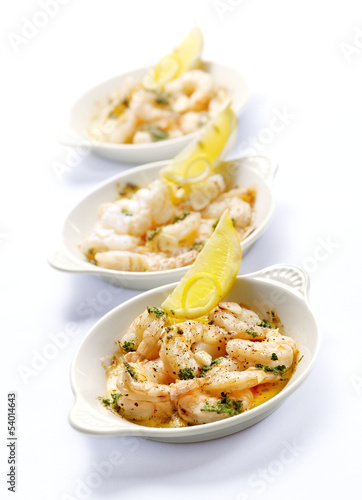 Photo: three bowls with prawns and garlic butter three bowls with prawns and garlic butter