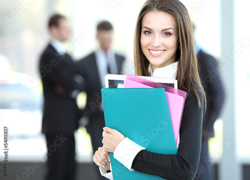 Photo: Face of beautiful woman on the background of business people Face of beautiful woman on the background of business people