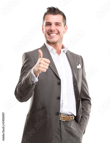Photo: Happy smiling young business man with thumbs up gesture Happy smiling young business man with thumbs up gesture
