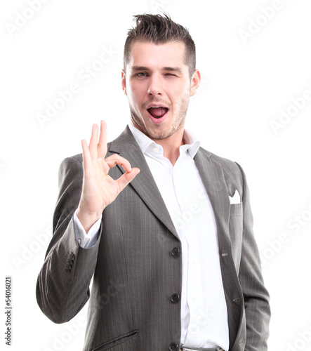 Photo: Happy smiling young business man with thumbs up gesture Happy smiling young business man with thumbs up gesture