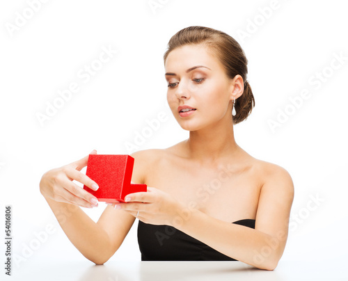 Photo: woman with earrings, wedding ring and gift box woman with earrings, wedding ring and gift box