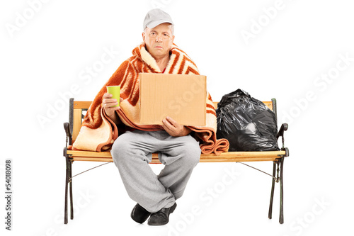 Photo: Homeless man sitting on a bench Homeless man sitting on a bench