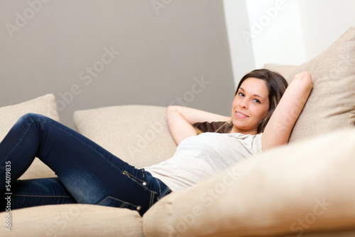 Photo: Young woman relaxing on the sofa Young woman relaxing on the sofa