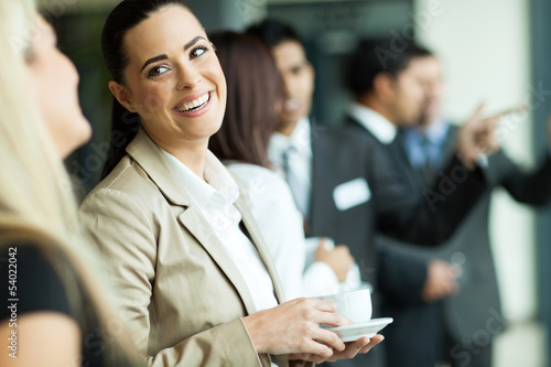 Photo: businesswoman having fun conversation with colleague during brea businesswoman having fun conversation with colleague during brea