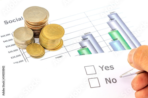 Photo: Yes no check box with coins and business graph Yes no check box with coins and business graph
