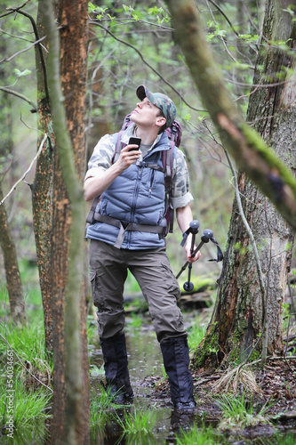 Photo: lost hiker in forest with smart phone lost hiker in forest with smart phone