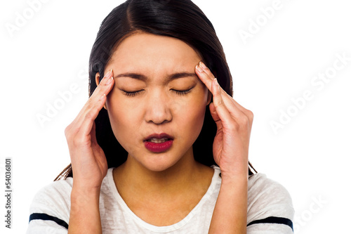 Photo: Girl having serious headache Girl having serious headache