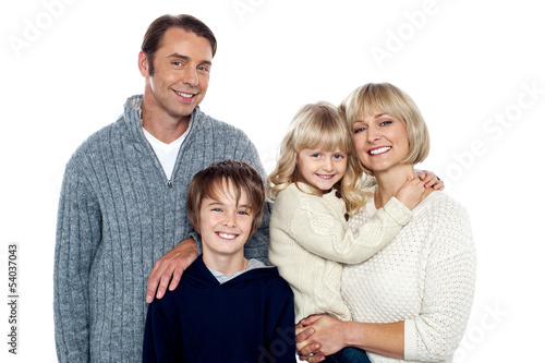 Photo: Portrait of friendly family of four in the studio Portrait of friendly family of four in the studio