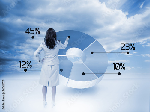 Photo: Businesswoman drawing a pie chart Businesswoman drawing a pie chart