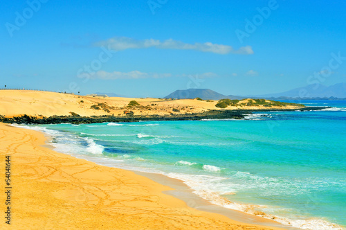 Photo: beach in Natural Park of Dunes of Corralejo in Fuerteventura, Sp beach in Natural Park of Dunes of Corralejo in Fuerteventura, Sp