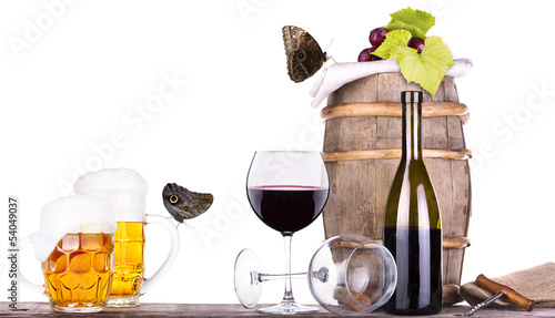 Photo: grapes on a barrel with corkscrew, beer and butterfly grapes on a barrel with corkscrew, beer and butterfly