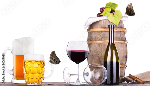 Photo: grapes on a barrel with corkscrew, beer and butterfly grapes on a barrel with corkscrew, beer and butterfly