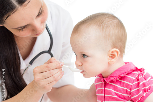 Photo: doctor giving drug to baby girl isolated on white doctor giving drug to baby girl isolated on white