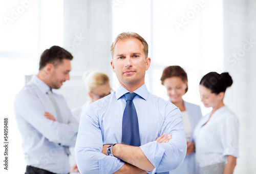 Photo: handsome businessman with team in office handsome businessman with team in office