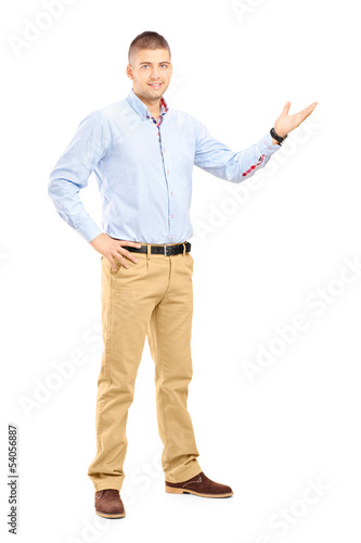 Photo: Full length portrait of a young handsome guy gesturing Full length portrait of a young handsome guy gesturing